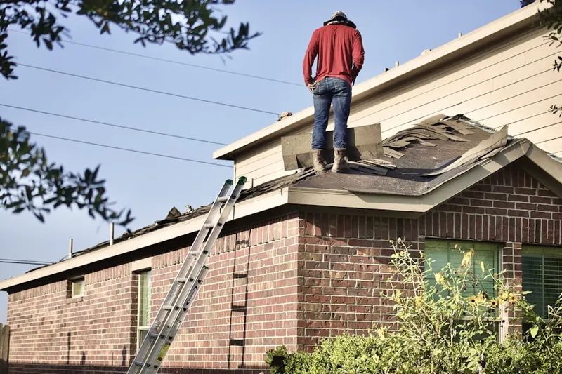 Professional roofer working on a residential roof in Sharpley